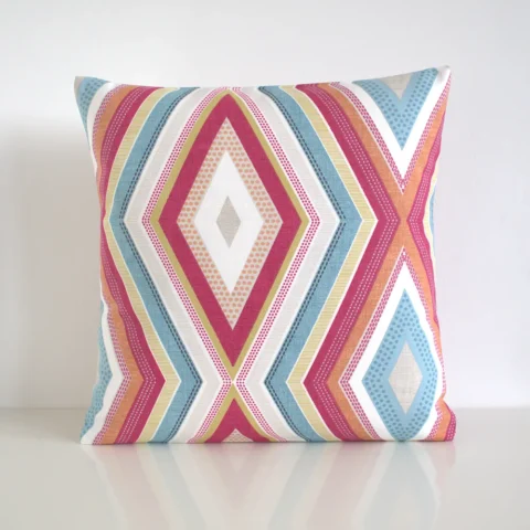 Multi coloured geometric cushion cover featuring a multi sized diamond pattern