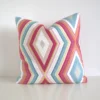 Multi coloured geometric cushion cover featuring a multi sized diamond pattern