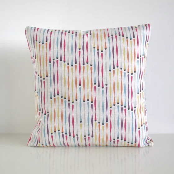 Multi coloured geometric cushion cover featuring a small twisted stripe shape pattern