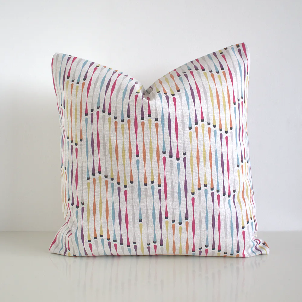 Multi coloured geometric cushion cover featuring a small twisted stripe shape pattern