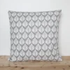 A grey and white cushion cover featuring a simple small scale floral pattern